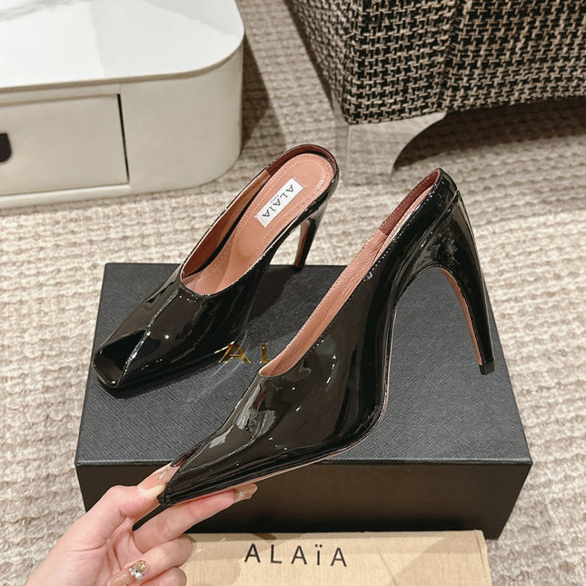 ALAIA SPIKE JEWEL MULES IN BLACK GLOSSY CALFSKIN