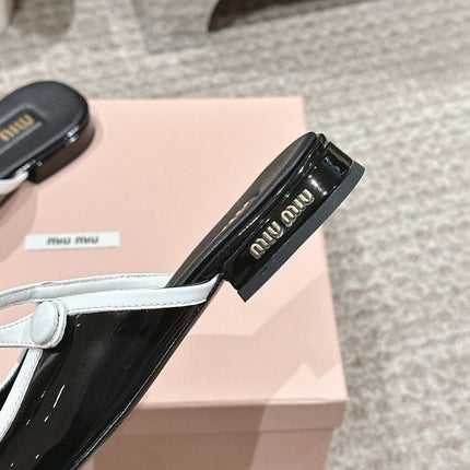 FLAT MULE IN BLACK AND WHITE PATENT CALFSKIN