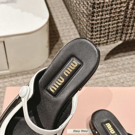 FLAT MULE IN BLACK AND WHITE PATENT CALFSKIN