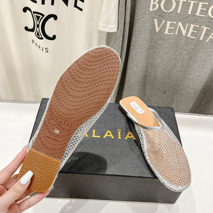 ALAIA FLAT MULES IN SILVER MESH FISHNET
