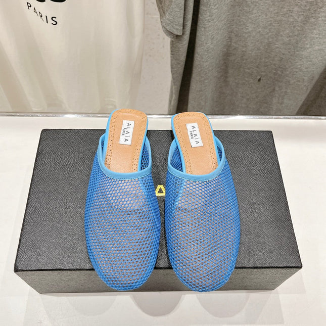 ALAIA FLAT MULES IN CERULEAN BLUE MESH FISHNET