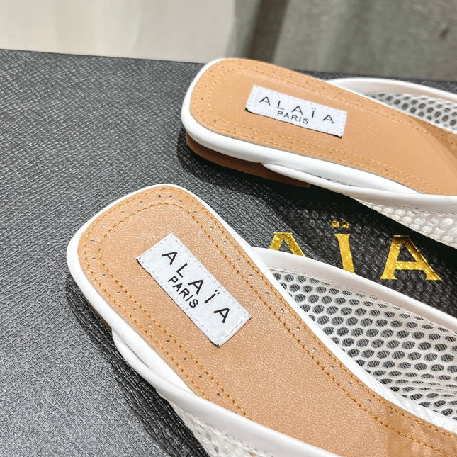 ALAIA FLAT MULES IN WHITE MESH FISHNET