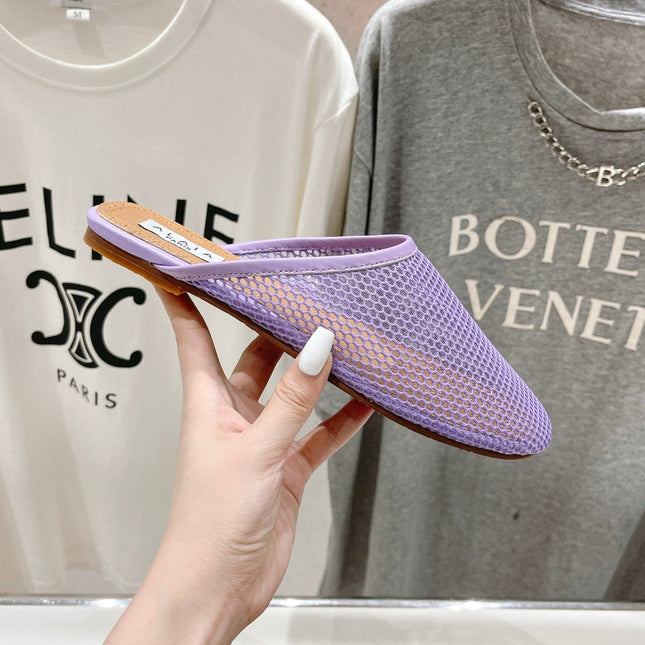 ALAIA FLAT MULES IN LIGHT PURPLE MESH FISHNET