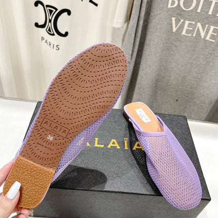 ALAIA FLAT MULES IN LIGHT PURPLE MESH FISHNET