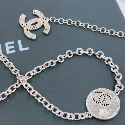 TWISTED CHAIN BELT WITH RHINESTONES AND LOGO PLATE IN SILVER TONE