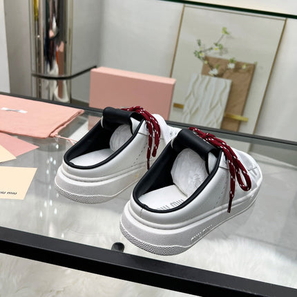 SNEAKER MULES IN BLACK AND WHITE CALFSKIN WHITE RED LACES