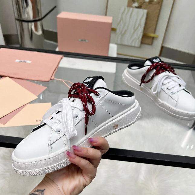SNEAKER MULES IN BLACK AND WHITE CALFSKIN WHITE RED LACES